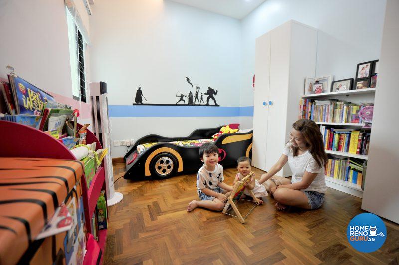 The wall mural spans the length of one wall above the batmobile-themed bed, inspiring superhero dreams!