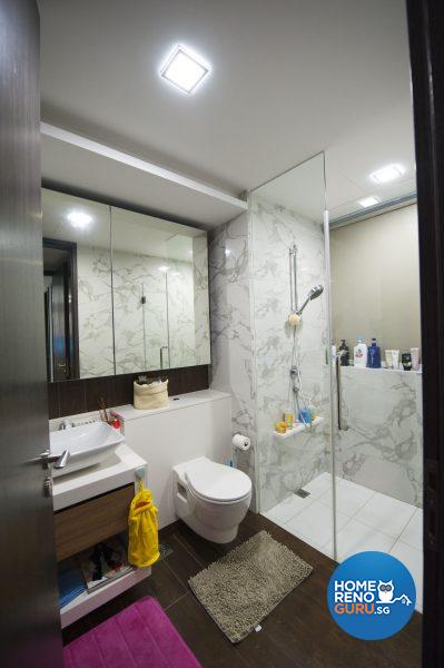 The luxurious fully tiled bathroom is illuminated with down lights