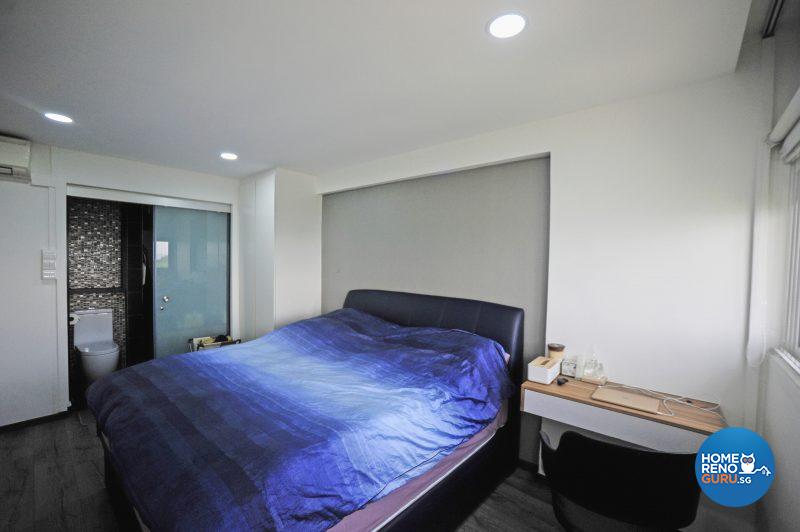 The pristine white of the master bedroom is relieved by a dove grey feature wall