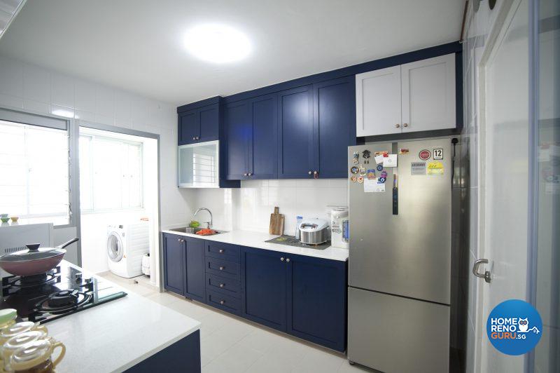 Blue cabinets with brass handles make a statement in the kitchen