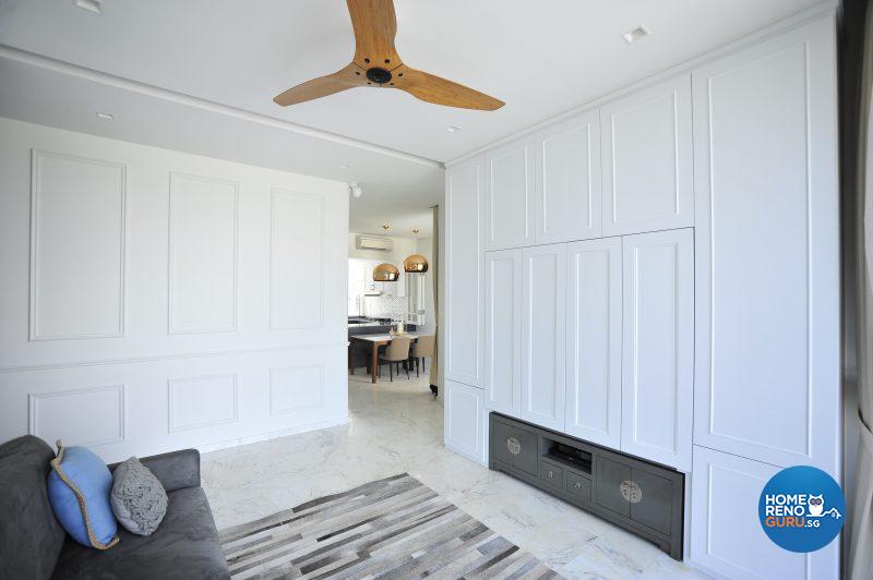 The TV set is concealed by sliding panels above an old Chinese chest, which came from the owners’ previous home