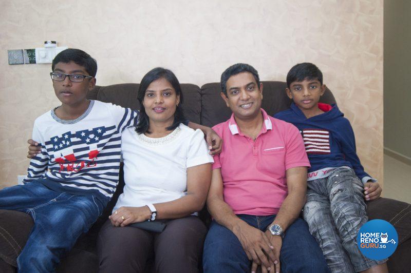 The family seated against a deep golden and caramel-coloured feature wall that was created using Nippon Paint Momento special effects paint