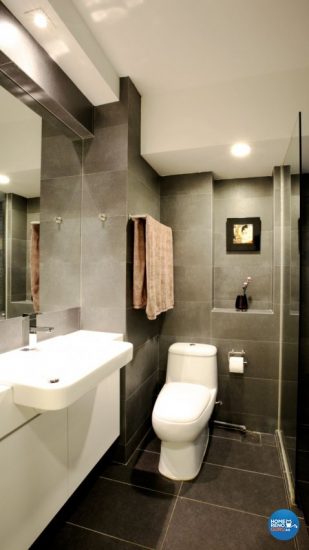 Bathroom with matching dark grey wall and floor tiles