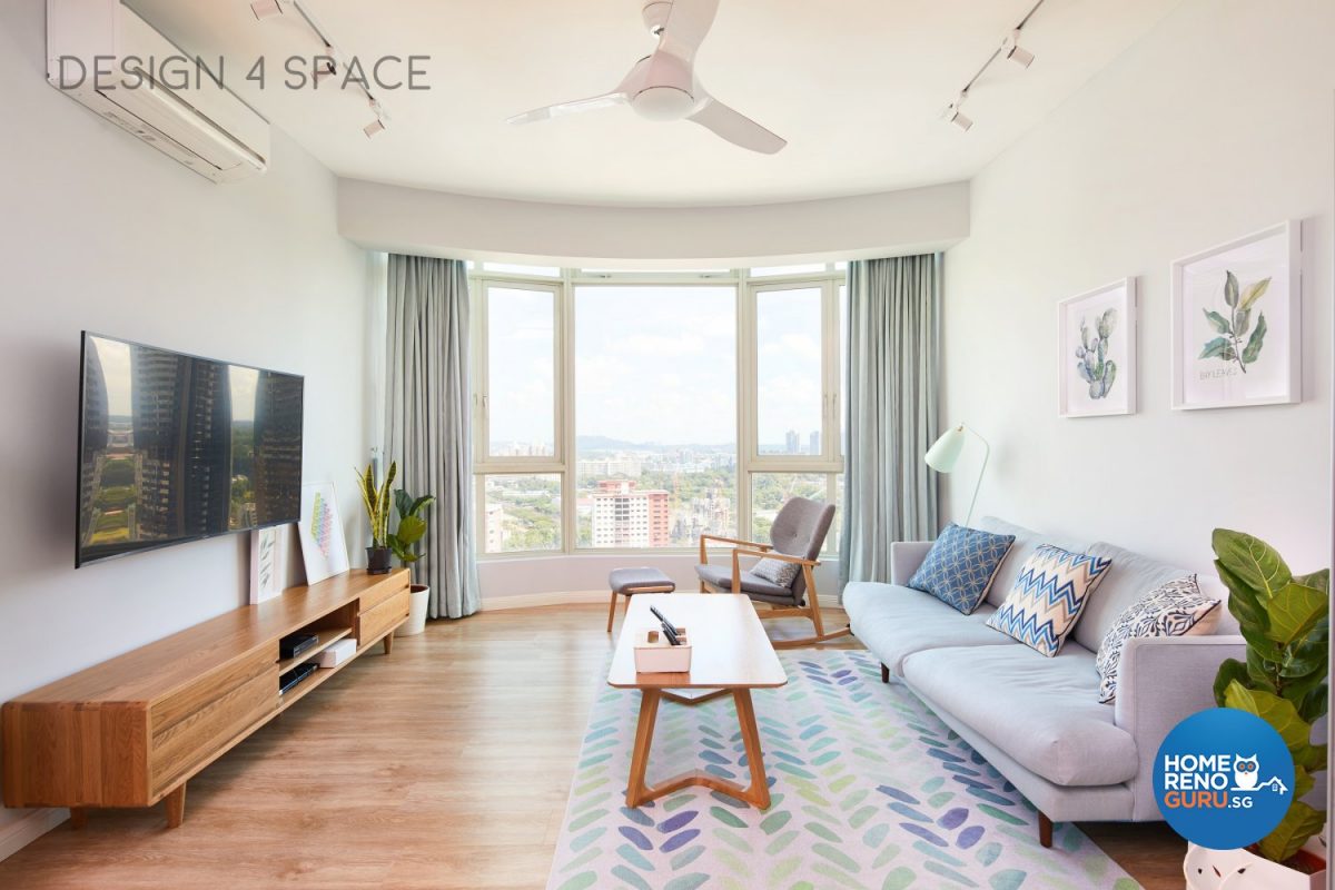 Modern condominium living room with blue sofa and wooden coffee table