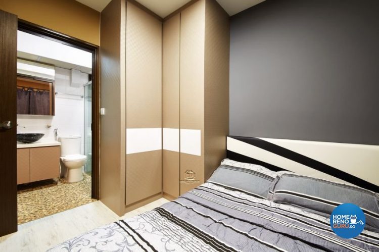 Bedroom with brown wardrobes and bed with black, grey and white stripes
