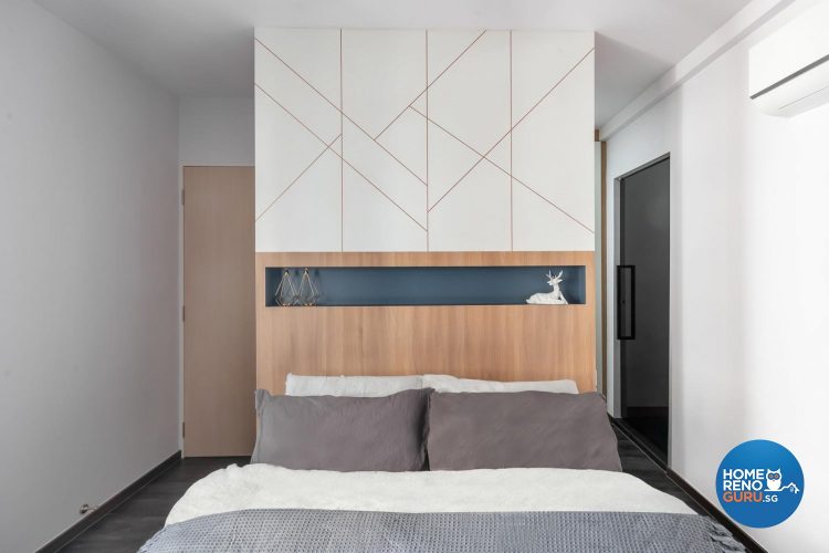 Bed with brown headboard and wall with intersecting lines