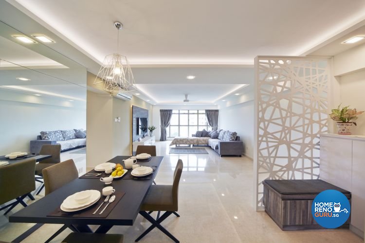 Dining room with black tables and chairs and white wall separator with overlapping lines