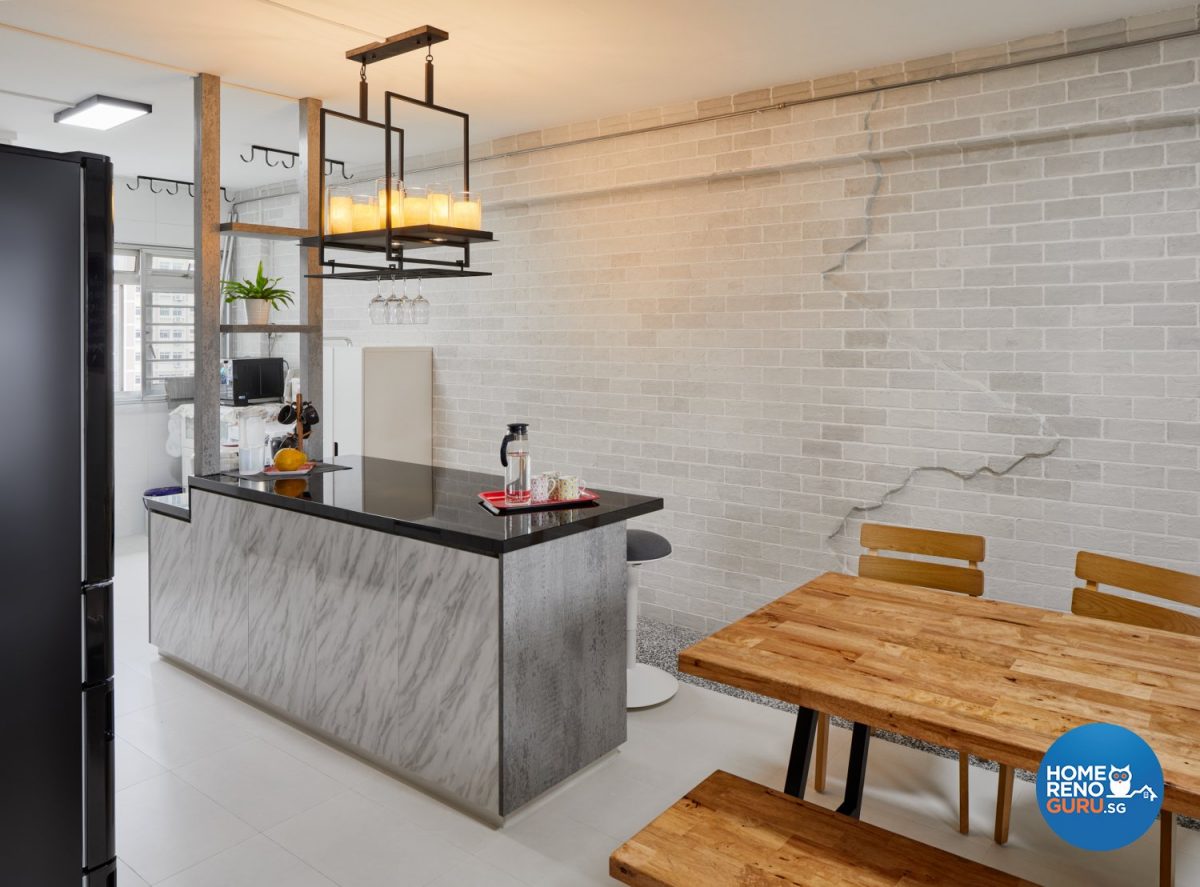 Wooden dining table and chairs, marble kitchen counter and hanging lights