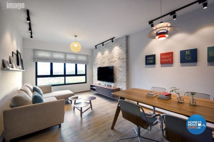 Brick feature wall behind the tv, round hanging lamp, sofa and dining table and chairs