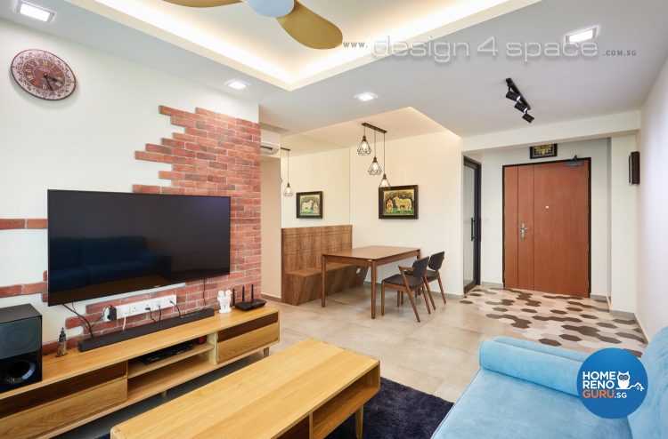 Half brick feature wall with wall-mounted tv, bright blue sofa and brown coffee table