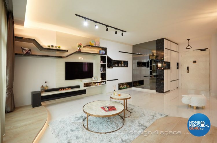 White circular coffee tables, light grey rug and wall-mounted tv in the living room