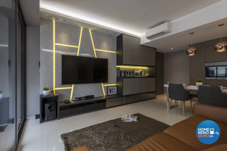 Grey wall with neon yellow lines, wall-mounted tv and brown rug