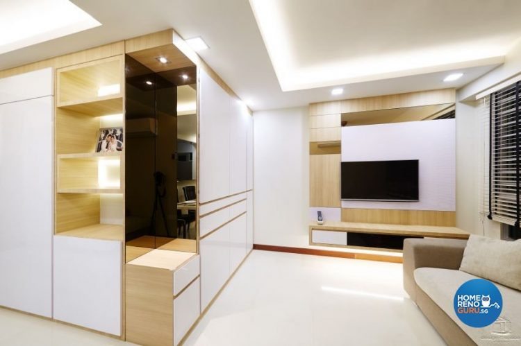 White walls with wooden rectangles and wall mounted tv