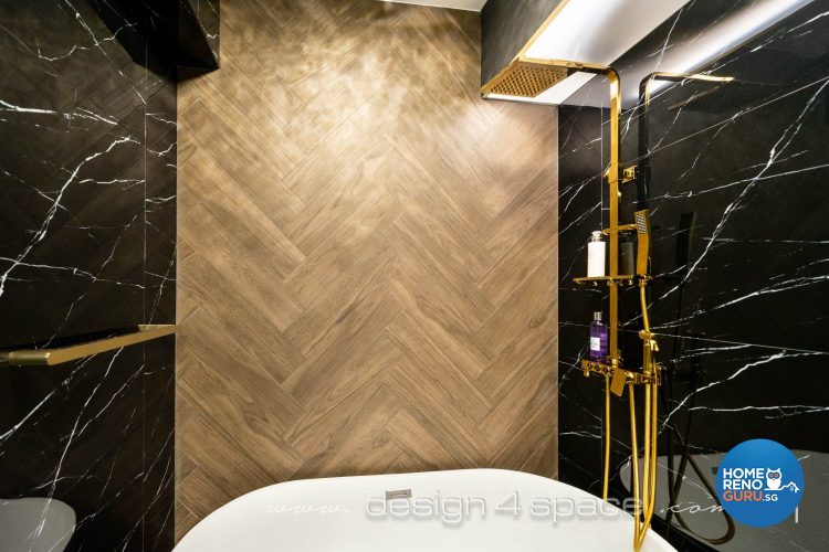 Golden standing shower and white tub, black marble wall and wooden feature wall