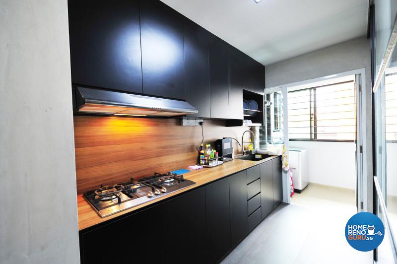 A wooden splashback and countertop distinguish the stylish, dark-toned kitchen
