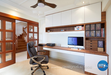 Study room with wooden furnishings and black office chair