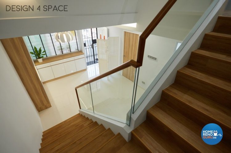 Stairs with wooden steps and glass railings with wooden handles