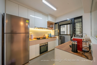 Kitchen with white cupboards and silver fridge