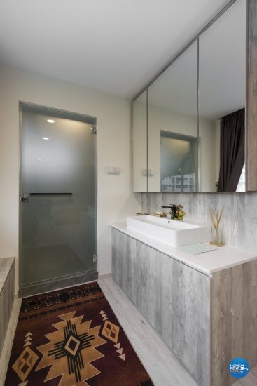 Long bathroom with multiple large wall-mounted cabinets with mirror doors