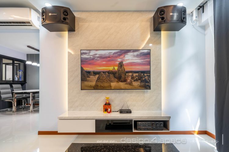 Wall-mounted TV with large speakers near the ceiling