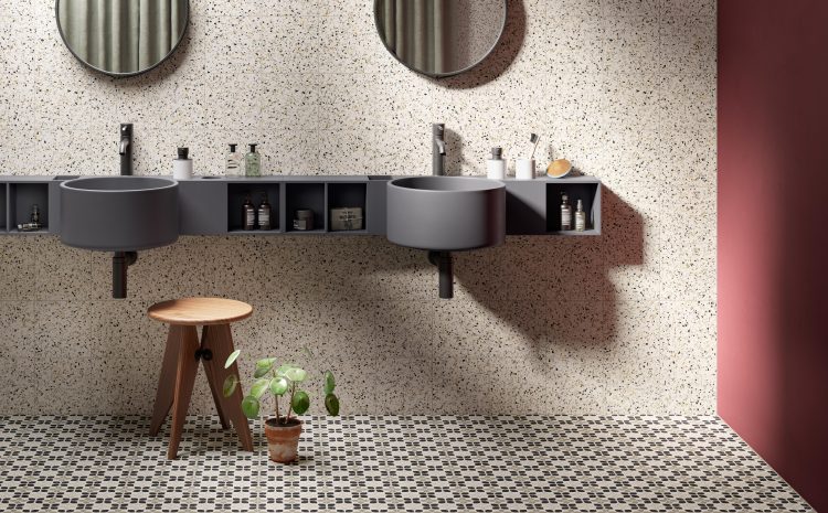 Toilet with 2 mirrors, sinks, and tiled floor