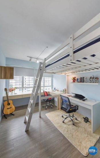 Study area below upper deck bed in a room with blue walls