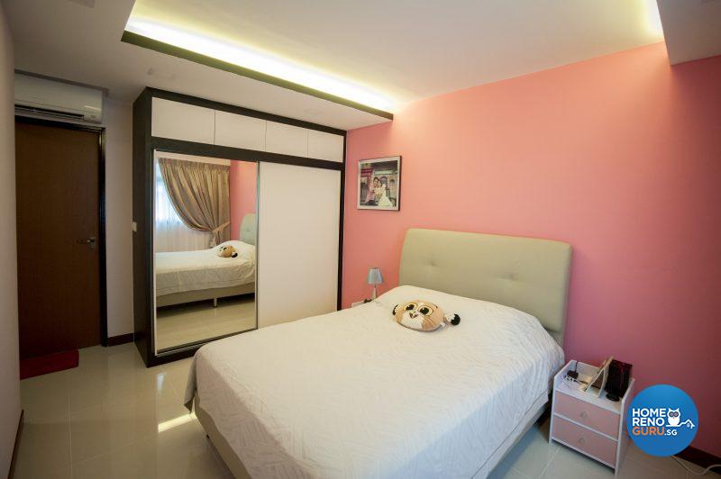 The master bedroom sports a feature wall in coral pink