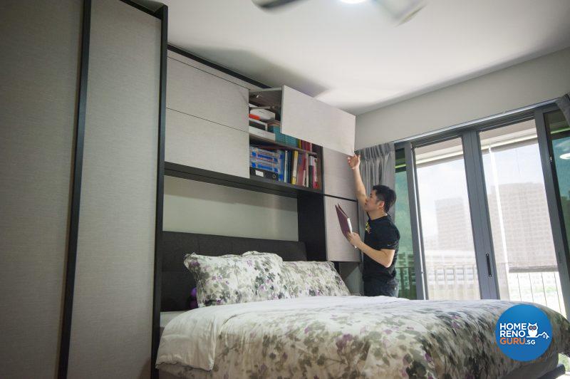 Charles lifts the hatch on the overhead storage in the master bedroom