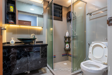 Bathroom with glass shower doors and dark marble counter