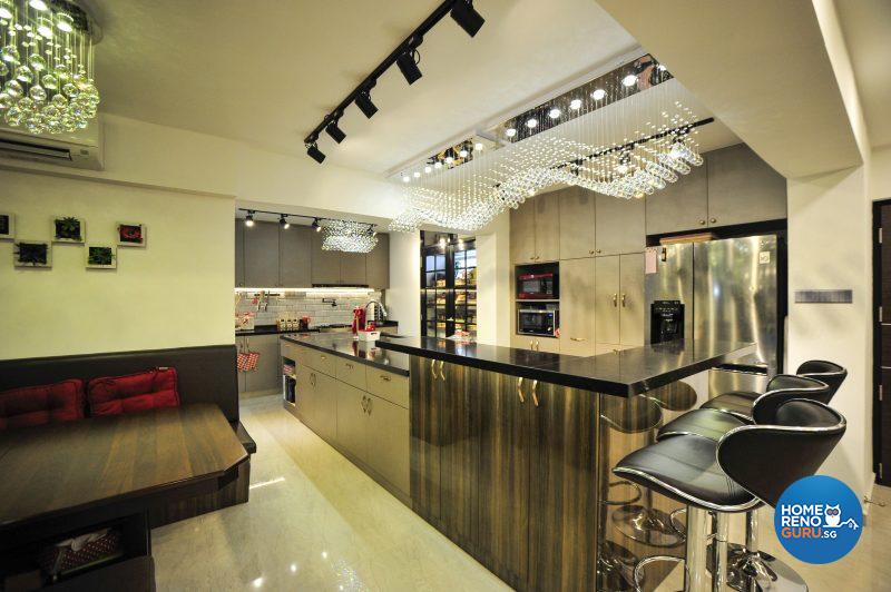 Chandelier lights are suspended over the luxuriously spacious kitchen counter