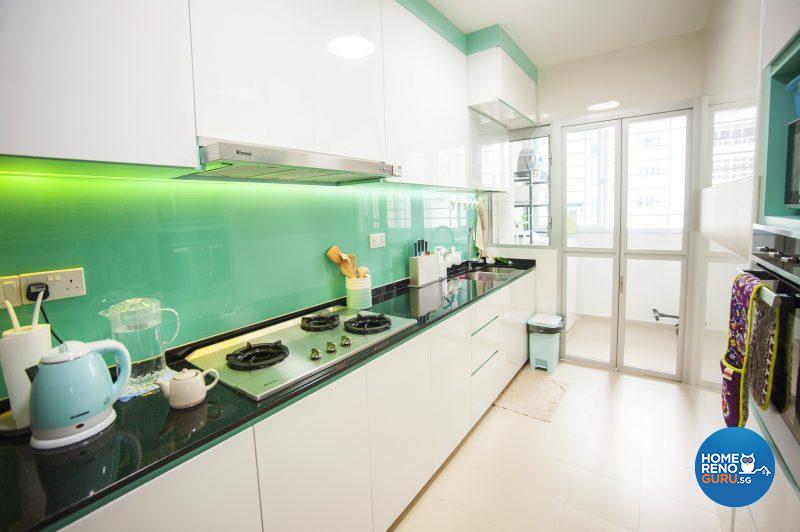 The spacious, functional kitchen is brought to life with black countertops and a turquoise tempered glass splashback