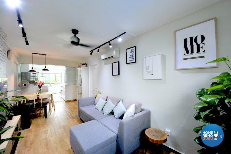 The living area is flanked by a feature wall and joins the kitchen
